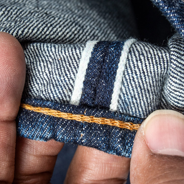 close-up example of a chain stitching and selvedge at denim jeans hem