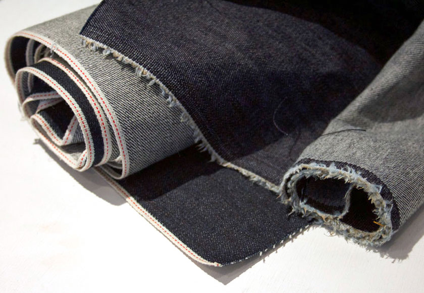 A close-up of selvedge and ordinary raw denim fabric to highlight the difference.