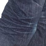 Side view of stretch marks on jeans