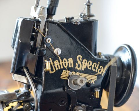 Close-up of a black vintage Union Special 43200G sewing machine used for chain stitch hemming on jeans