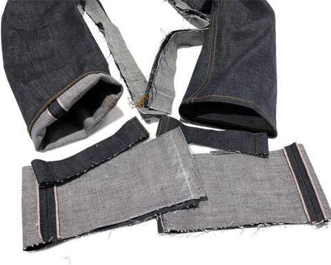 The hem of tailored jeans next to parts of the original leg size shows an example of what it means to have "tapered jeans alterations."