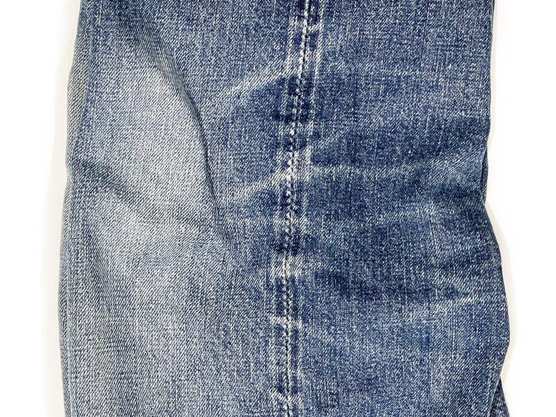 Close-up of denim train tracks on jeans outseam