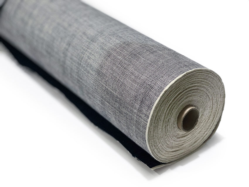 A roll of denim fabric depicts a wonderful example of what selvedge denim is by its distinct, tightly woven edges.