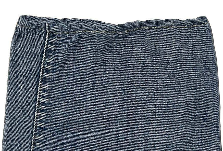 A close-up of bad chain stitching on the hem of a pair of Levi's denim jeans shows misalignment to create a roping effect, but instead causes a bad case of puckering.