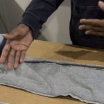 In a close-up of a jeans leg with twisting, denim designer Maurice Malone explains why a common denim issue is caused, either by shrinkage or improper sewing.