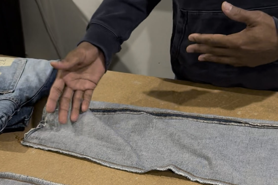 In a close-up of a jeans leg with twisting, denim designer Maurice Malone explains why a common denim issue is caused, either by shrinkage or improper sewing.