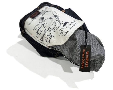 Signed handmade jeans with illustrated pocket bag and Williamsburg Garment Company tag, representing the upcoming denim workshop where attendees learn how to make jeans.