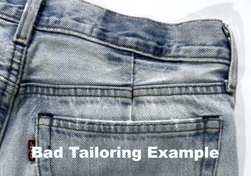 Exterior view of jeans waistband showing a darted seam from a poorly executed waist alteration